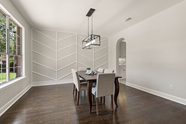 850 White River Dr, Prosper, TX 75078 - dining area featuring dark wood finished floors, baseboards, arched walkways, and built in features