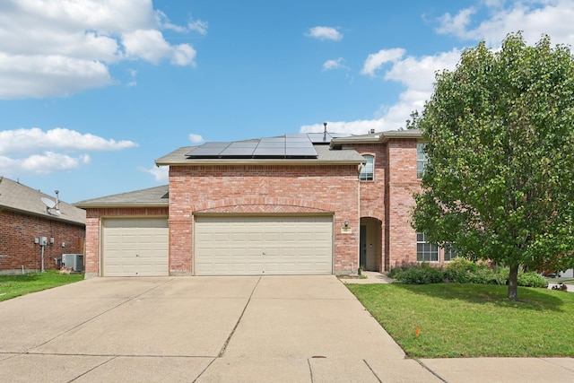 6128 Redear Dr, Fort Worth, TX 76179 - traditional-style house featuring concrete driveway, a garage, central AC, a front yard, and solar panels
