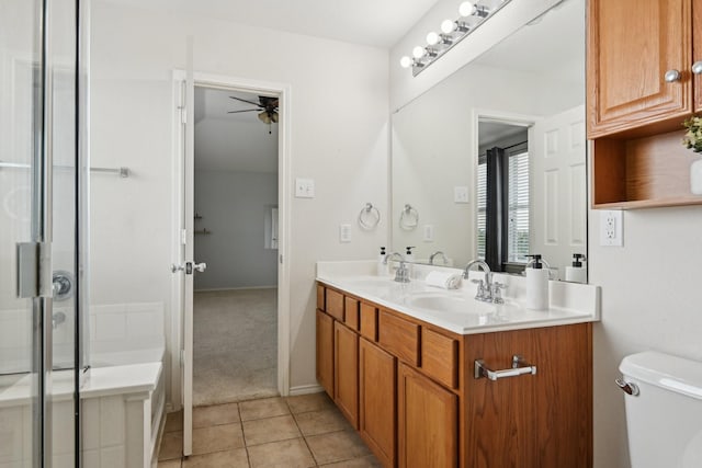 6128 Redear Dr, Fort Worth, TX 76179 - bathroom with ceiling fan, double vanity, toilet, tile patterned flooring, and a shower with door