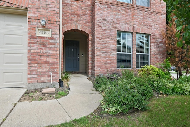 6128 Redear Dr, Fort Worth, TX 76179 - property entrance featuring brick siding and an attached garage