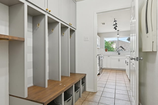 6128 Redear Dr, Fort Worth, TX 76179 - mudroom featuring light tile patterned floors and a sink