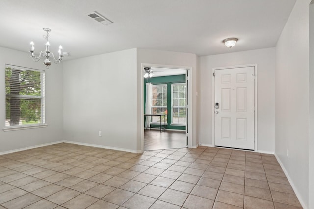 6128 Redear Dr, Fort Worth, TX 76179 - entrance foyer with healthy amount of natural light, light tile patterned floors, a chandelier, and baseboards
