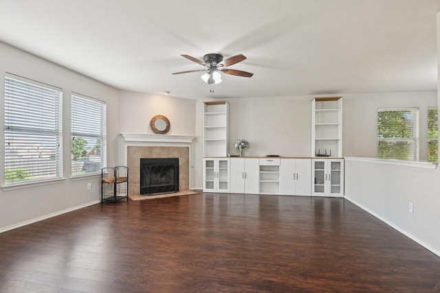 6128 Redear Dr, Fort Worth, TX 76179 - unfurnished living room with plenty of natural light, ceiling fan, a tiled fireplace, and wood finished floors