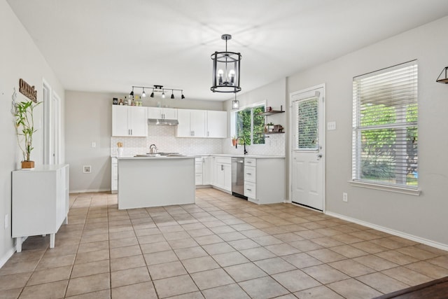 6128 Redear Dr, Fort Worth, TX 76179 - kitchen featuring stainless steel dishwasher, decorative backsplash, under cabinet range hood, a chandelier, and plenty of natural light