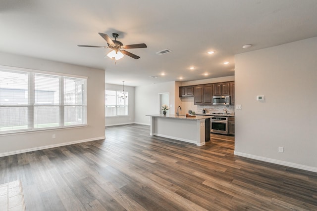 2028 Proteus Dr, Haslet, TX 76052 - kitchen with stainless steel appliances, ceiling fan, dark wood-style flooring, dark brown cabinetry, and recessed lighting
