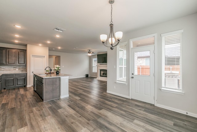 2028 Proteus Dr, Haslet, TX 76052 - kitchen featuring a sink, ceiling fan, dark wood-type flooring, a fireplace, and recessed lighting