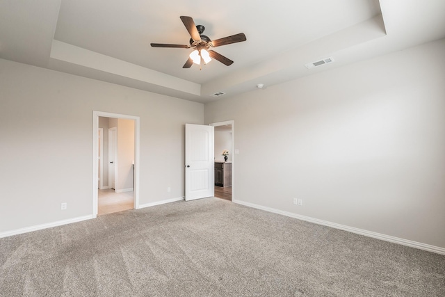 2028 Proteus Dr, Haslet, TX 76052 - unfurnished bedroom featuring light carpet, a tray ceiling, and baseboards