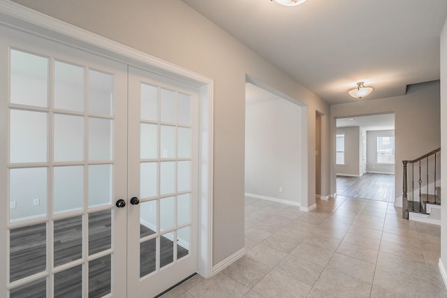 2028 Proteus Dr, Haslet, TX 76052 - hall with french doors, baseboards, stairway, and light tile patterned floors