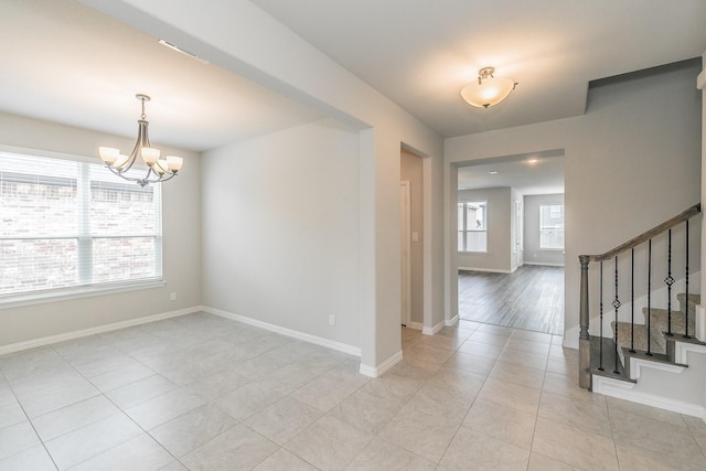 2028 Proteus Dr, Haslet, TX 76052 - spare room with light tile patterned flooring, stairs, a chandelier, and baseboards