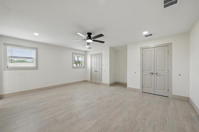2614 E Mitchell St, Arlington, TX 76010 - unfurnished bedroom featuring two closets, light wood-style flooring, baseboards, recessed lighting, and ceiling fan