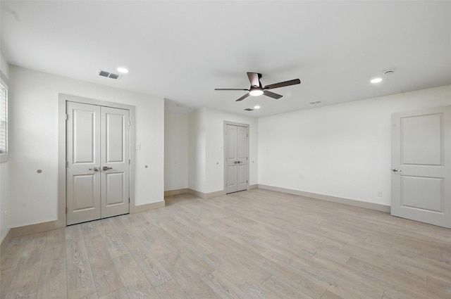 2614 E Mitchell St, Arlington, TX 76010 - unfurnished bedroom with two closets, light wood finished floors, baseboards, recessed lighting, and a ceiling fan