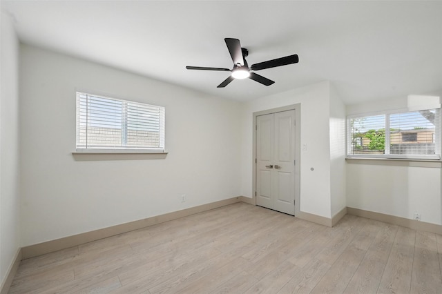 2614 E Mitchell St, Arlington, TX 76010 - empty room with light wood-style floors, a ceiling fan, and baseboards