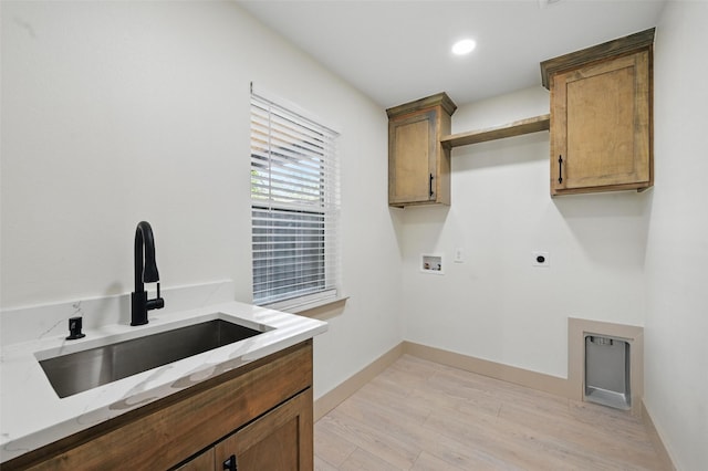 2614 E Mitchell St, Arlington, TX 76010 - laundry room featuring hookup for an electric dryer, cabinet space, hookup for a washing machine, light wood-style flooring, and baseboards