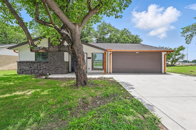 2614 E Mitchell St, Arlington, TX 76010 - view of front of home featuring concrete driveway, a garage, a front yard, and stone siding