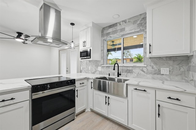 2614 E Mitchell St, Arlington, TX 76010 - kitchen featuring appliances with stainless steel finishes, island exhaust hood, a sink, decorative backsplash, and white cabinets