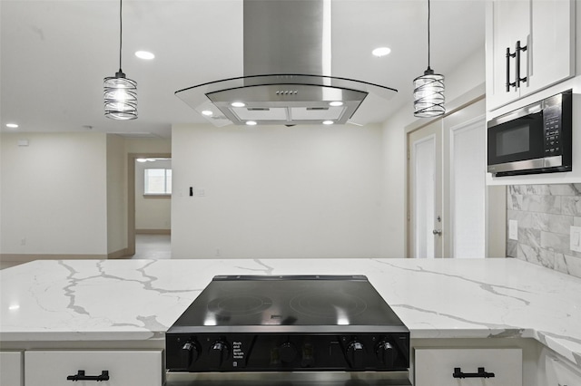2614 E Mitchell St, Arlington, TX 76010 - kitchen featuring stainless steel microwave, island exhaust hood, range with electric stovetop, tasteful backsplash, and recessed lighting