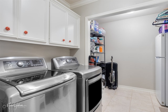 9406 Prestonwood Cir, Shreveport, LA 71115 - laundry area featuring cabinet space, separate washer and dryer, ornamental molding, light tile patterned floors, and baseboards
