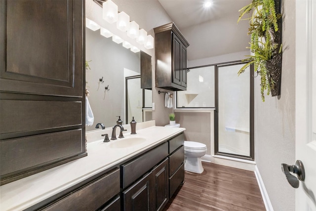 225 County Road 3525, Paradise, TX 76073 - bathroom featuring toilet, a stall shower, vanity, and wood finished floors