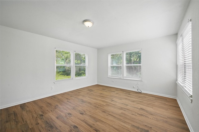 210 N 5th Ave, Denison, TX 75021 - spare room with wood finished floors and baseboards