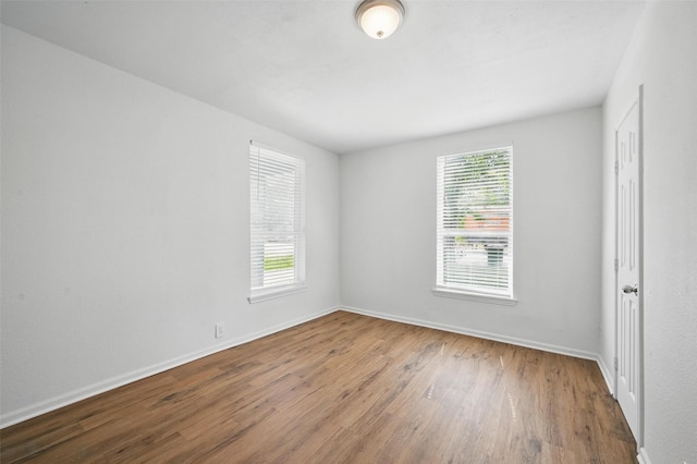 210 N 5th Ave, Denison, TX 75021 - empty room with wood finished floors and baseboards