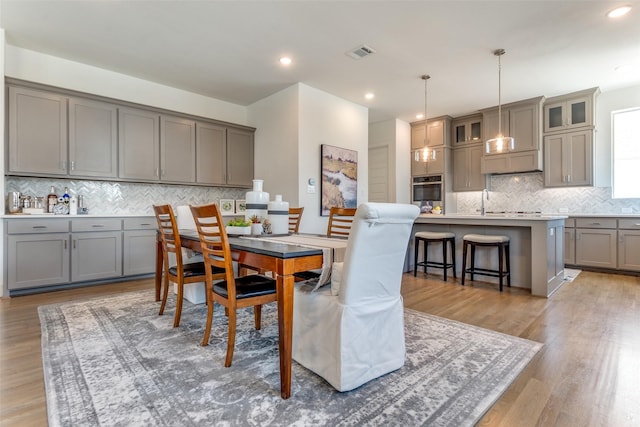 8120 Radnor Rd, Dallas, TX 75231 - dining room with light wood-style flooring and recessed lighting
