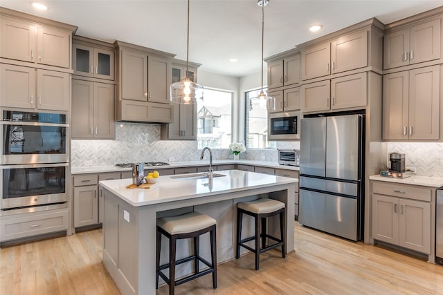 8120 Radnor Rd, Dallas, TX 75231 - kitchen featuring appliances with stainless steel finishes, a sink, gray cabinets, backsplash, and recessed lighting