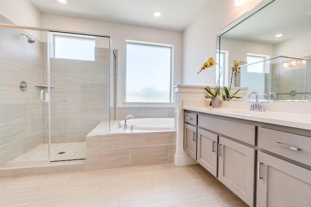 8120 Radnor Rd, Dallas, TX 75231 - full bath featuring vanity, a bath, a shower stall, tile patterned flooring, and recessed lighting
