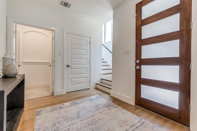 8120 Radnor Rd, Dallas, TX 75231 - entryway featuring stairs, baseboards, and wood finished floors
