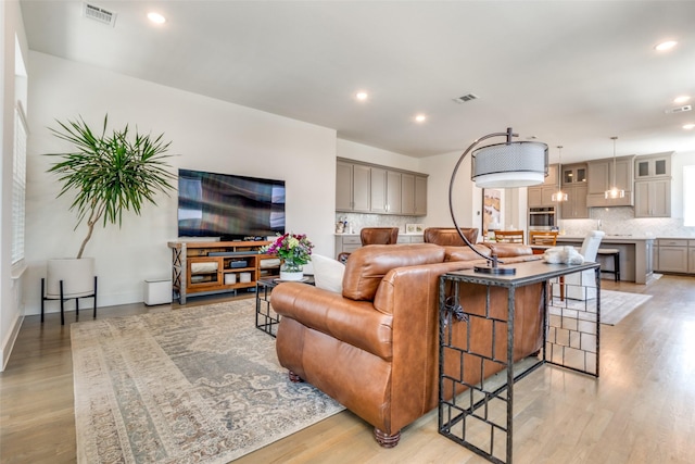 8120 Radnor Rd, Dallas, TX 75231 - living room with light wood-style flooring, recessed lighting, and baseboards