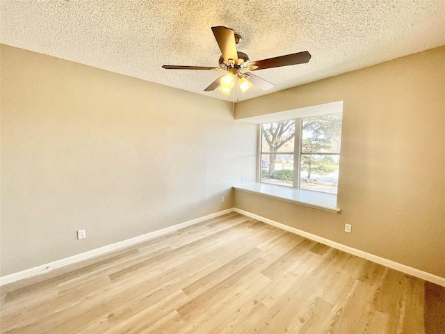 12331 Ferris Creek Ln, Dallas, TX 75243 - empty room with light wood-style floors, ceiling fan, baseboards, and a textured ceiling