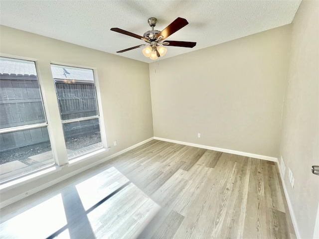12331 Ferris Creek Ln, Dallas, TX 75243 - unfurnished room featuring light wood-style flooring, baseboards, a ceiling fan, and a textured ceiling