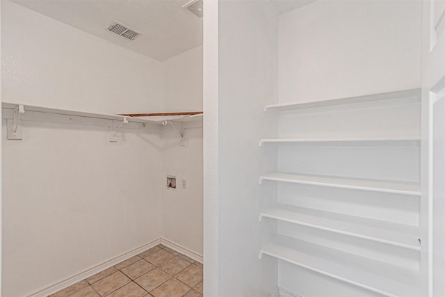 1301 Hennessey Ct, Fort Worth, TX 76131 - walk in closet featuring light tile patterned floors
