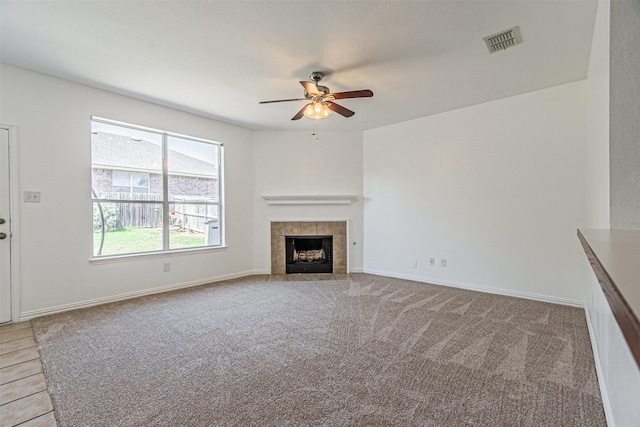 1301 Hennessey Ct, Fort Worth, TX 76131 - unfurnished living room with ceiling fan, a tiled fireplace, light carpet, and baseboards