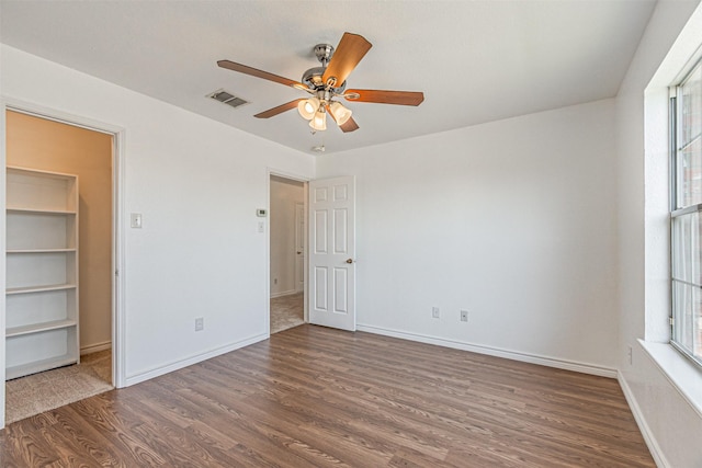 1301 Hennessey Ct, Fort Worth, TX 76131 - unfurnished bedroom with wood finished floors, multiple windows, baseboards, and a ceiling fan