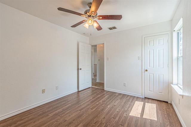 1301 Hennessey Ct, Fort Worth, TX 76131 - unfurnished bedroom with wood finished floors, multiple windows, baseboards, and a ceiling fan