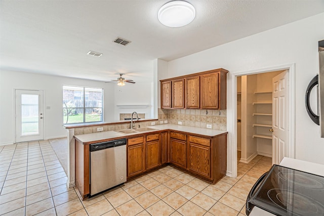 1301 Hennessey Ct, Fort Worth, TX 76131 - kitchen featuring stainless steel dishwasher, a sink, brown cabinets, and light tile patterned flooring