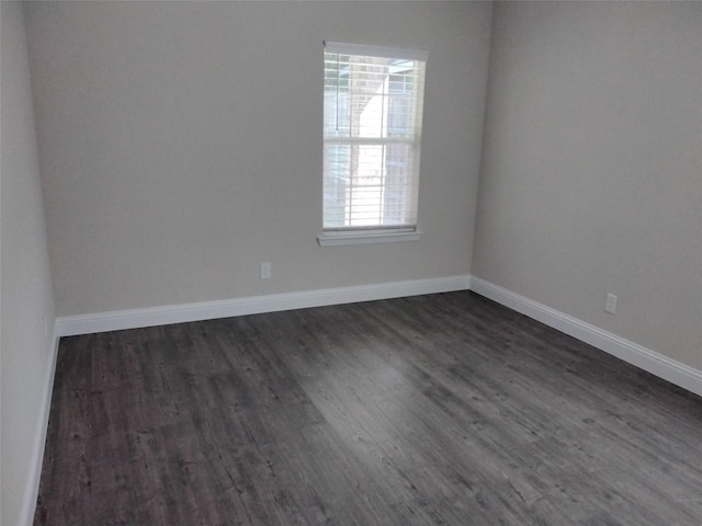 899 E Jefferson St, Van Alstyne, TX 75495 - empty room with dark wood finished floors and baseboards