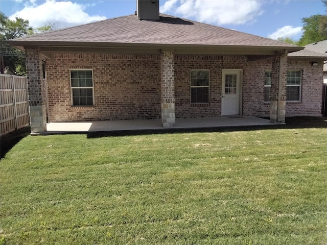 899 E Jefferson St, Van Alstyne, TX 75495 - back of property featuring a patio, roof with shingles, brick siding, and a chimney