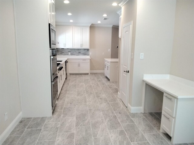 899 E Jefferson St, Van Alstyne, TX 75495 - kitchen featuring decorative backsplash, stainless steel microwave, light countertops, white cabinetry, and recessed lighting