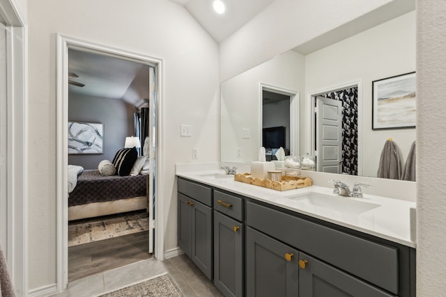1104 Egret Way, Celina, TX 75009 - ensuite bathroom with double vanity, tile patterned flooring, and vaulted ceiling