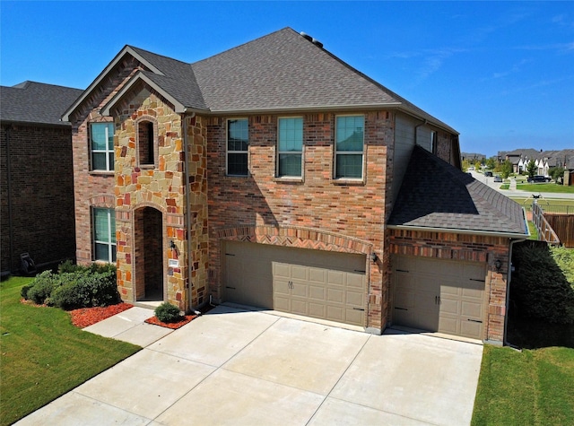 2809 Lakeside Dr, Aubrey, TX 76227 - traditional-style house with roof with shingles, concrete driveway, a garage, and stone siding