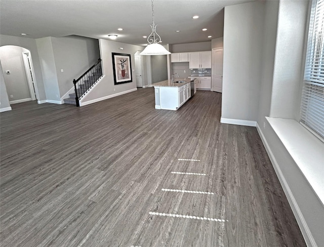 2809 Lakeside Dr, Aubrey, TX 76227 - kitchen featuring open floor plan, arched walkways, white cabinets, dark wood-type flooring, and recessed lighting
