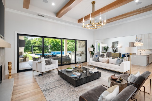 4155 American Pharoah Way, Celina, TX 75009 - living area featuring a chandelier, a towering ceiling, beamed ceiling, light wood finished floors, and a premium fireplace