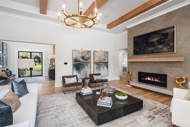 4155 American Pharoah Way, Celina, TX 75009 - living room with a chandelier, wood finished floors, a towering ceiling, a tiled fireplace, and beamed ceiling