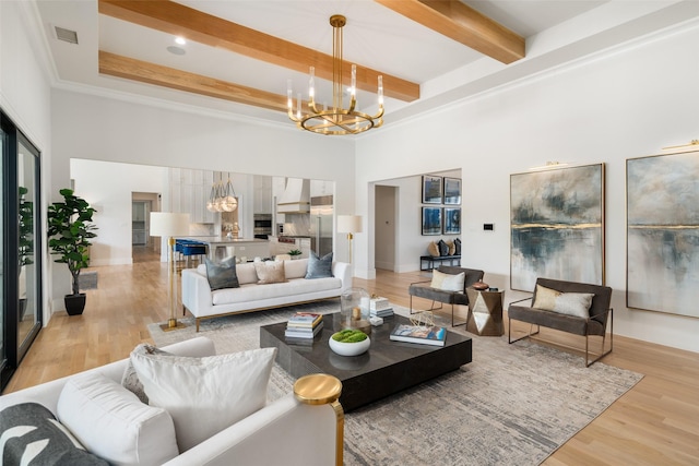 4155 American Pharoah Way, Celina, TX 75009 - living area with a chandelier, a high ceiling, beamed ceiling, light wood finished floors, and baseboards
