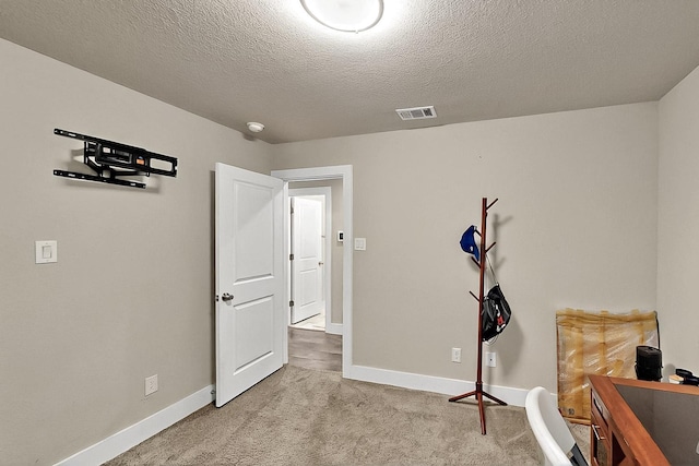2613 Rochester St, Dallas, TX 75215 - exercise room with light colored carpet, baseboards, and a textured ceiling