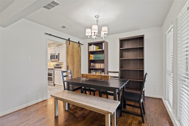 10420 Carry Back Cir, Dallas, TX 75229 - dining room with a chandelier, a barn door, and wood finished floors