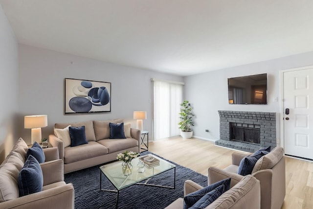 1810 N Garrett Ave Unit 216, Dallas, TX 75206 - living room featuring wood finished floors, a fireplace, and baseboards