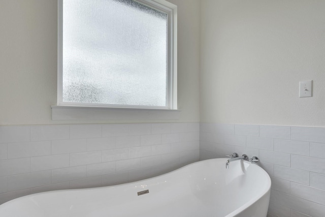 219 Mulkey Rd, Waxahachie, TX 75167 - full bathroom with a soaking tub and tile walls