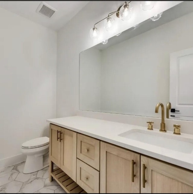 219 Mulkey Rd, Waxahachie, TX 75167 - bathroom with vanity, toilet, and marble finish flooring